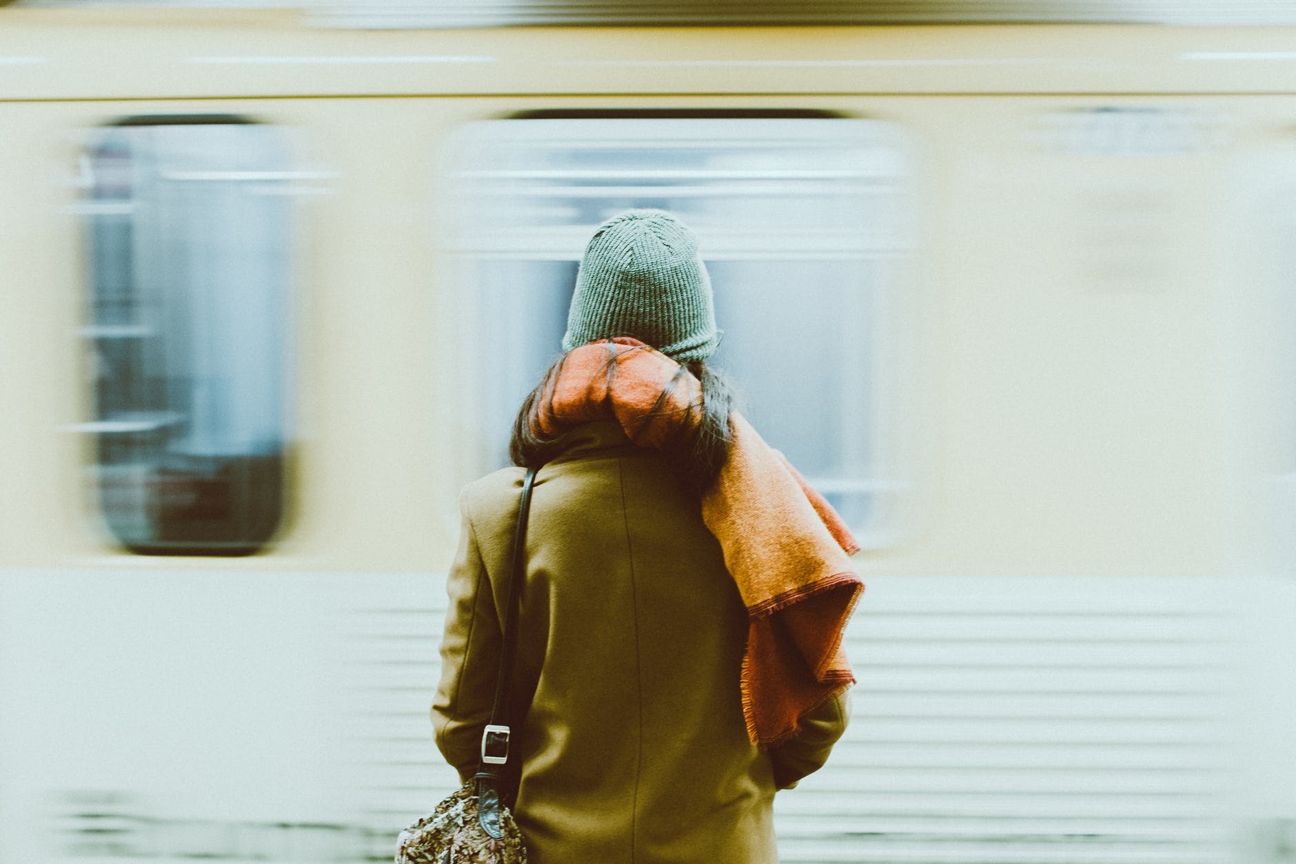 time lapse photography of person standing near train