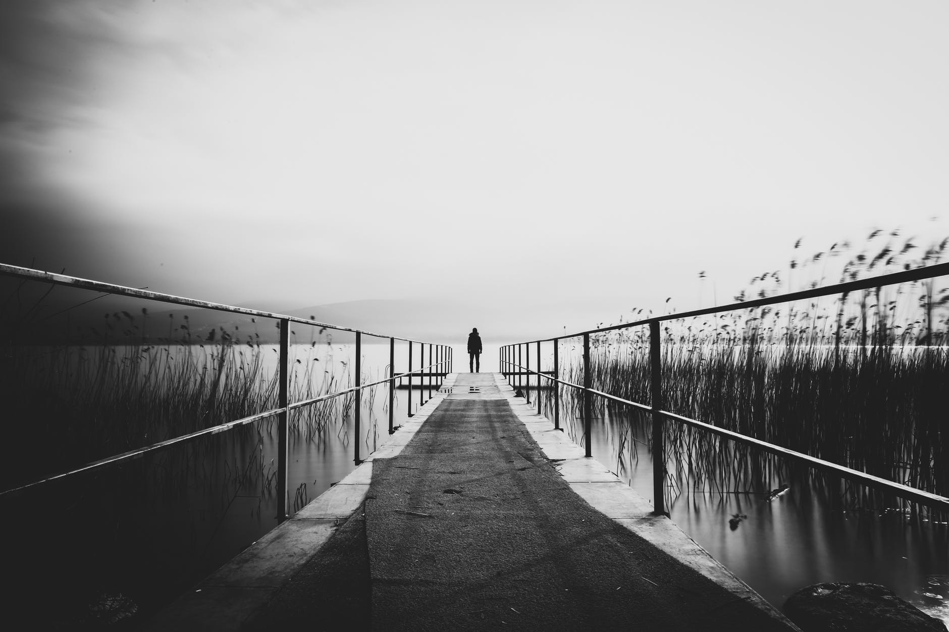 man standing on wooden dock