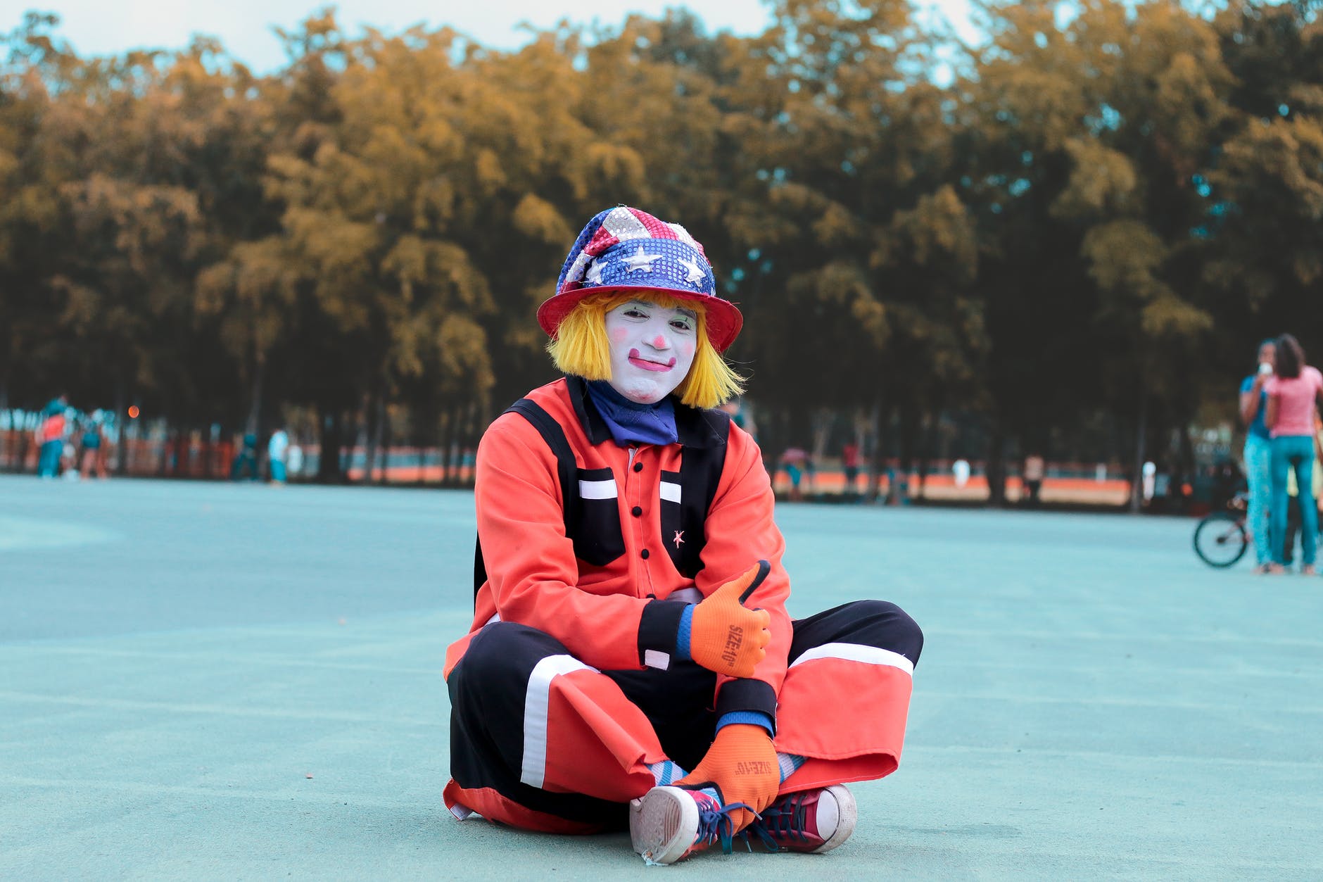 low angle of clown sitting on ground