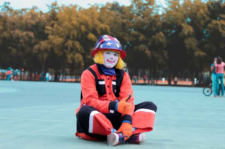 low angle of clown sitting on ground