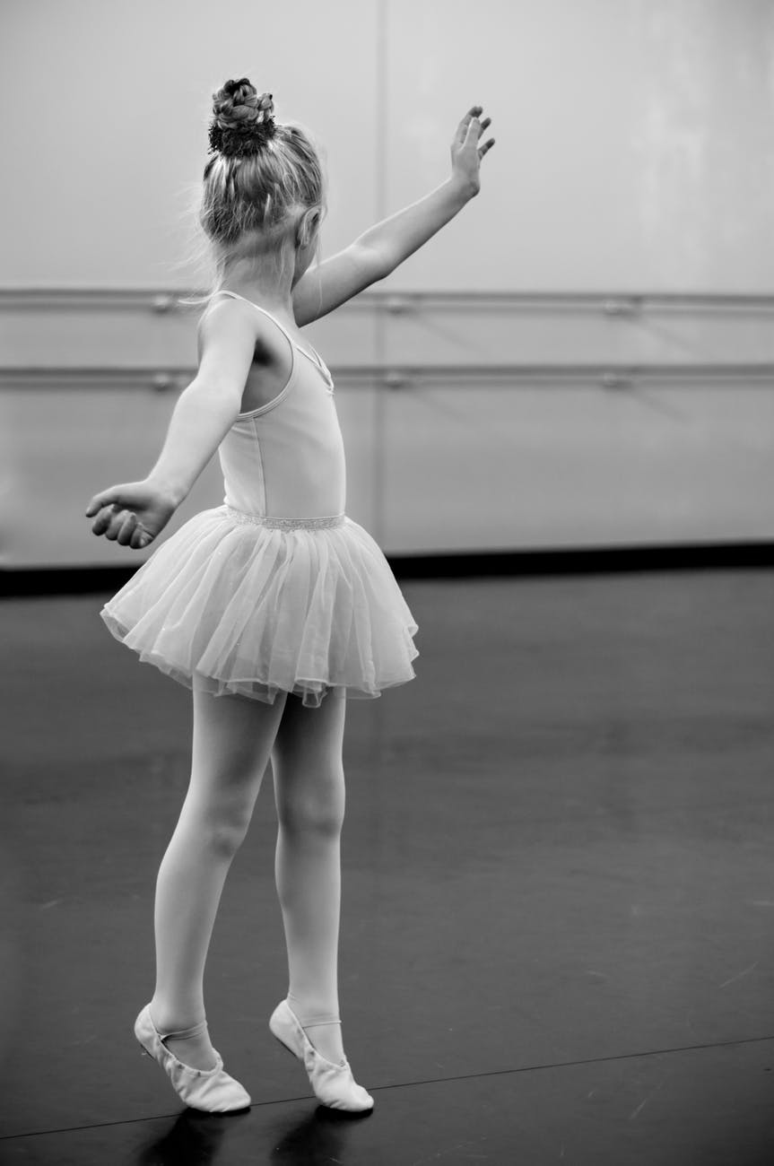 grayscale photography of girl doing ballet
